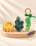 Lavender Garden: gold Rose 6, green and black Leaf and green Grape soaps, from left to right.